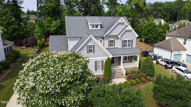 2661 Silver Bend Dr, Apex, NC 27539 - view of front of property with a porch, roof with shingles, stairs, and view of wooded area