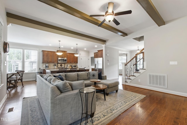 2661 Silver Bend Dr, Apex, NC 27539 - living area with beam ceiling, a ceiling fan, baseboards, stairway, and dark wood-type flooring