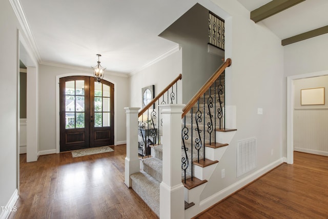 2661 Silver Bend Dr, Apex, NC 27539 - foyer featuring a chandelier, wood finished floors, french doors, stairway, and arched walkways