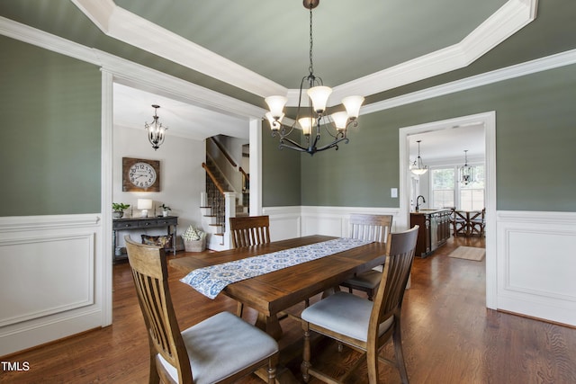 2661 Silver Bend Dr, Apex, NC 27539 - dining space featuring a chandelier, ornamental molding, a wainscoted wall, stairway, and dark wood finished floors
