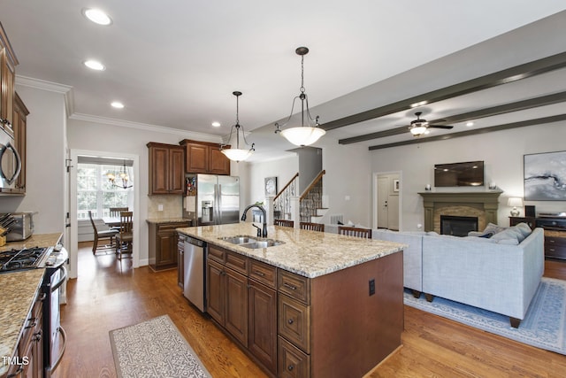 2661 Silver Bend Dr, Apex, NC 27539 - kitchen with a sink, stainless steel appliances, wood finished floors, a center island with sink, and recessed lighting