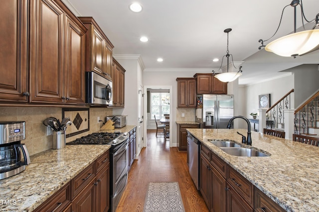 2661 Silver Bend Dr, Apex, NC 27539 - kitchen featuring appliances with stainless steel finishes, a sink, dark wood-type flooring, recessed lighting, and decorative light fixtures