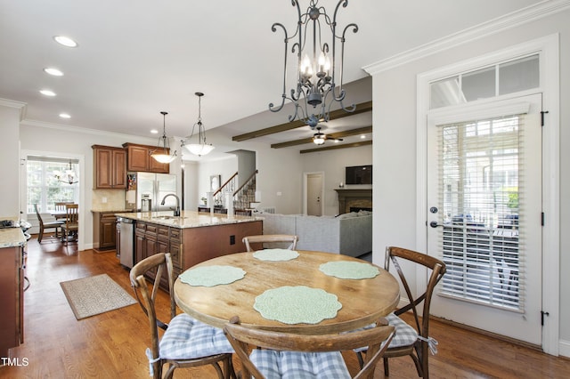 2661 Silver Bend Dr, Apex, NC 27539 - dining space with stairs, recessed lighting, a fireplace, dark wood finished floors, and crown molding