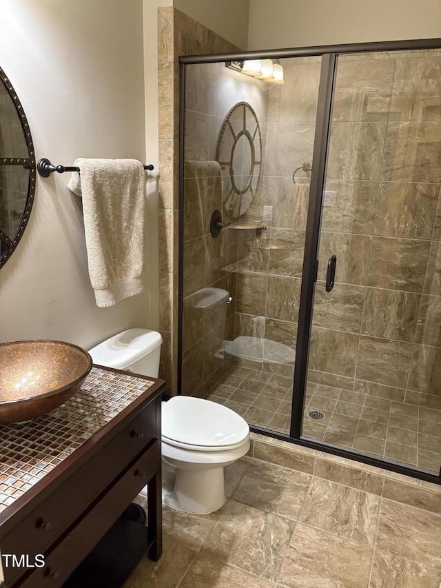 2661 Silver Bend Dr, Apex, NC 27539 - bathroom featuring toilet, vanity, a shower stall, and stone finish floors