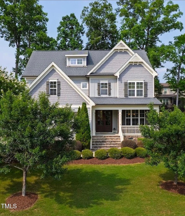 2661 Silver Bend Dr, Apex, NC 27539 - view of front facade with covered porch, a front lawn, and roof with shingles