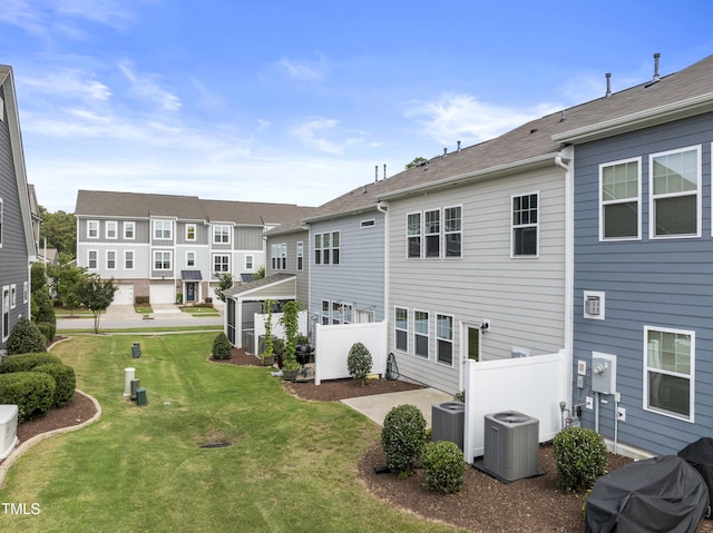 409 Rhamkatte Rd, Holly Springs, NC 27540 - back of property featuring cooling unit, a lawn, and a residential view