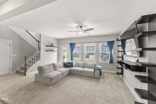 409 Rhamkatte Rd, Holly Springs, NC 27540 - living area with ceiling fan, carpet flooring, stairs, and baseboards