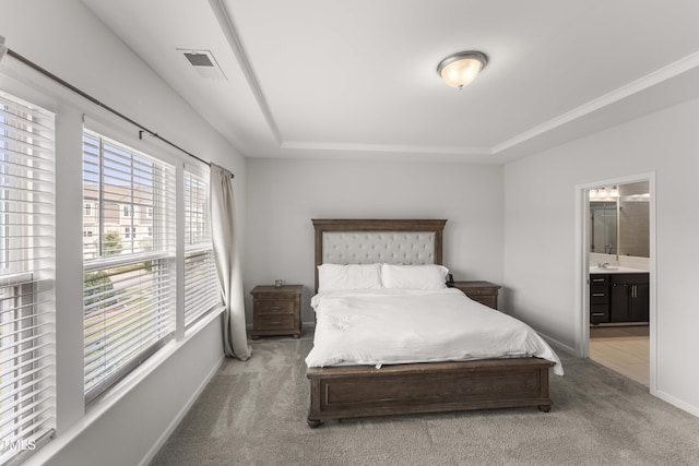 409 Rhamkatte Rd, Holly Springs, NC 27540 - bedroom with a tray ceiling, carpet floors, ensuite bathroom, a sink, and baseboards