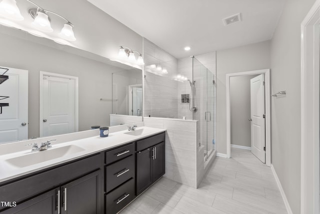 409 Rhamkatte Rd, Holly Springs, NC 27540 - full bathroom with double vanity, a shower stall, and baseboards