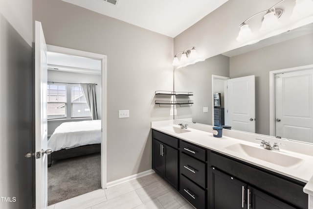 409 Rhamkatte Rd, Holly Springs, NC 27540 - ensuite bathroom with double vanity, baseboards, and tile patterned floors