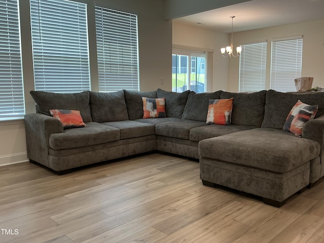 1116 Sidney Creek Dr Unit 1116, Zebulon, NC 27597 - living room with a chandelier, light wood-style flooring, and baseboards