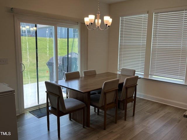 1116 Sidney Creek Dr Unit 1116, Zebulon, NC 27597 - dining space with a chandelier, wood finished floors, and baseboards