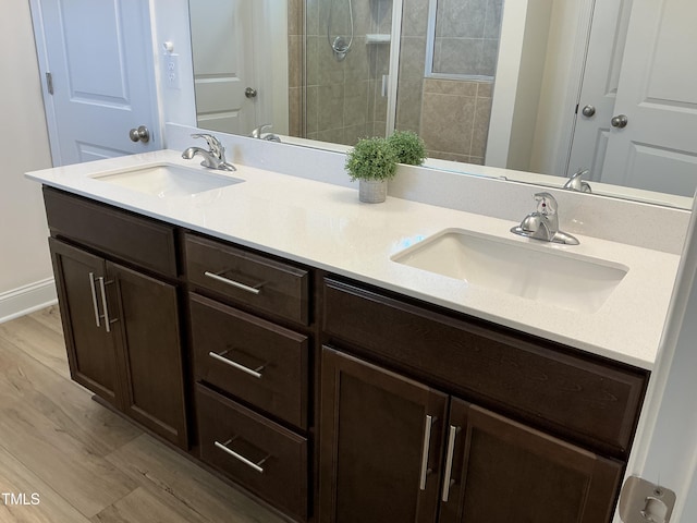 1116 Sidney Creek Dr Unit 1116, Zebulon, NC 27597 - full bath with double vanity, tiled shower, and wood finished floors