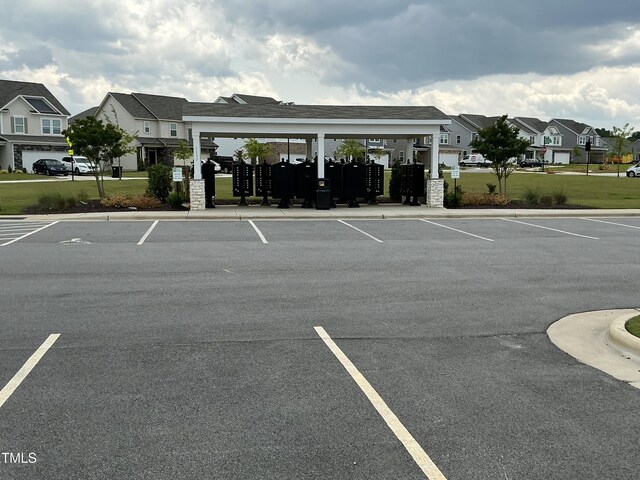 1116 Sidney Creek Dr Unit 1116, Zebulon, NC 27597 - uncovered parking lot with mail area and a residential view