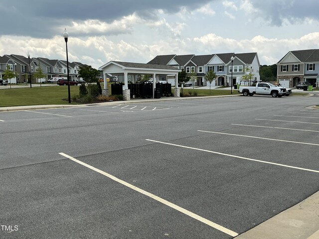 1116 Sidney Creek Dr Unit 1116, Zebulon, NC 27597 - uncovered parking lot featuring a residential view