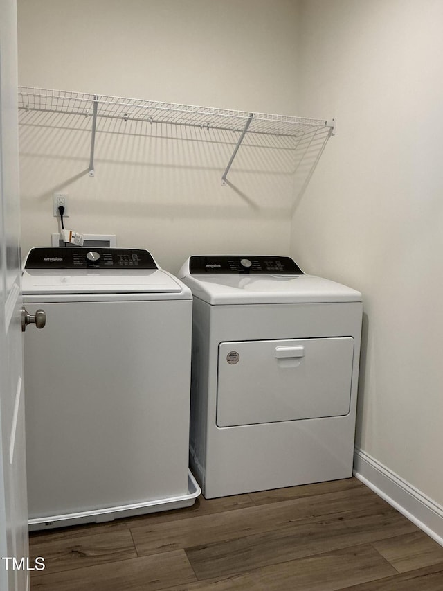 1116 Sidney Creek Dr Unit 1116, Zebulon, NC 27597 - washroom featuring independent washer and dryer, dark wood finished floors, and baseboards