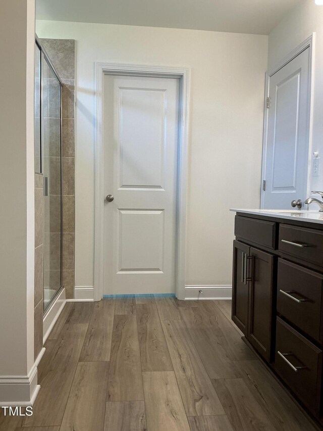 1116 Sidney Creek Dr Unit 1116, Zebulon, NC 27597 - bathroom featuring vanity, a stall shower, wood finished floors, and baseboards