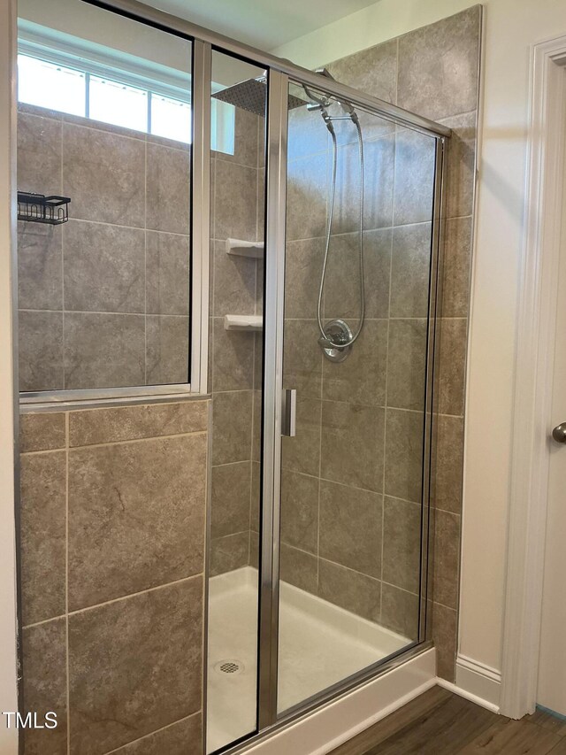 1116 Sidney Creek Dr Unit 1116, Zebulon, NC 27597 - full bathroom with a shower stall, wood finished floors, and baseboards