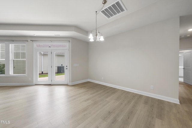 537 Bramble Ln, Clayton, NC 27527 - spare room with light wood finished floors and a chandelier