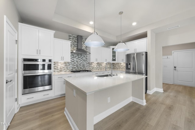 537 Bramble Ln, Clayton, NC 27527 - kitchen featuring wall chimney exhaust hood, stainless steel appliances, decorative backsplash, light wood-style flooring, and recessed lighting
