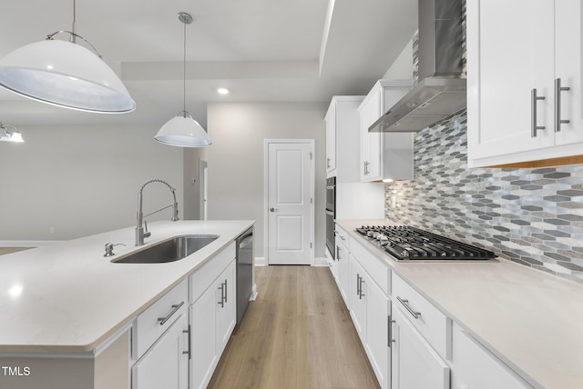 537 Bramble Ln, Clayton, NC 27527 - kitchen featuring wall chimney range hood, appliances with stainless steel finishes, light countertops, tasteful backsplash, and white cabinetry
