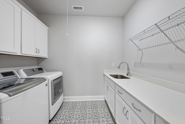 537 Bramble Ln, Clayton, NC 27527 - laundry room featuring washing machine and dryer, cabinet space, and light tile patterned floors