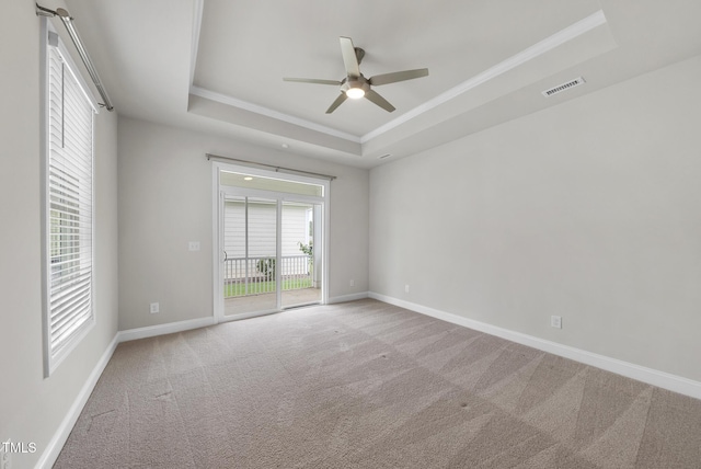 537 Bramble Ln, Clayton, NC 27527 - spare room featuring a tray ceiling, crown molding, carpet, and a ceiling fan