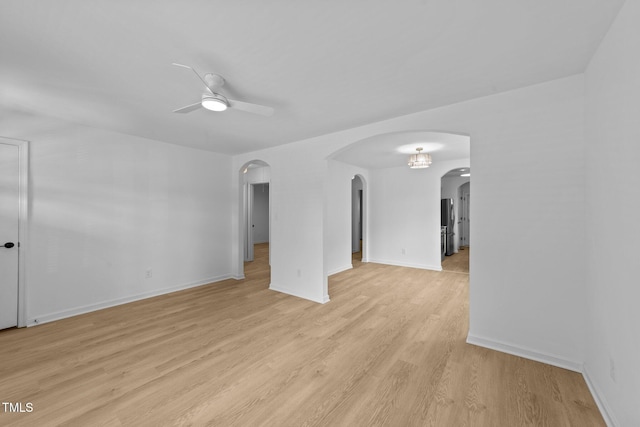 413 Top Greene Ln, Raleigh, NC 27601 - unfurnished room with ceiling fan, arched walkways, light wood-style flooring, and baseboards