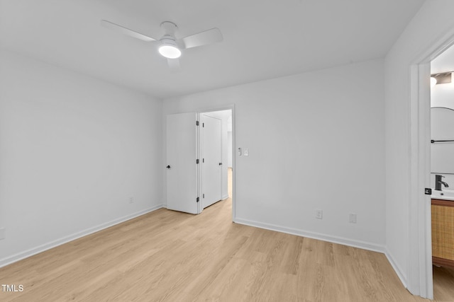 413 Top Greene Ln, Raleigh, NC 27601 - empty room featuring light wood-style flooring, ceiling fan, and baseboards