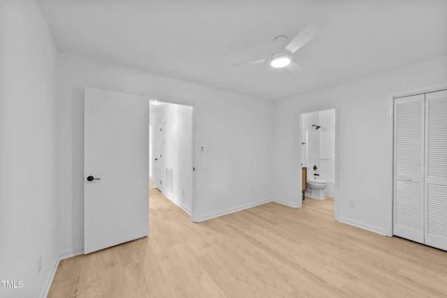 413 Top Greene Ln, Raleigh, NC 27601 - unfurnished bedroom with light wood-style floors, baseboards, connected bathroom, and a closet