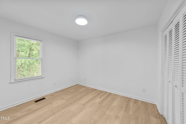 413 Top Greene Ln, Raleigh, NC 27601 - unfurnished bedroom featuring light wood finished floors, baseboards, and a closet