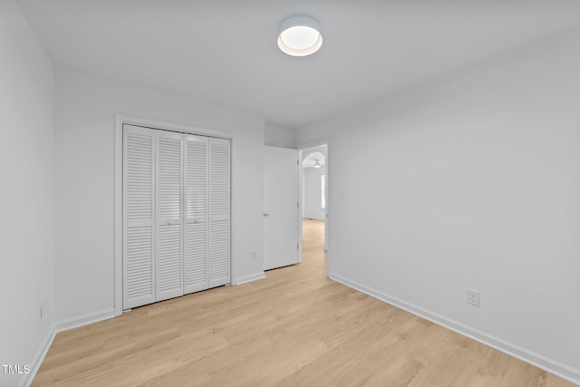 413 Top Greene Ln, Raleigh, NC 27601 - unfurnished bedroom with wood finished floors, baseboards, and a closet