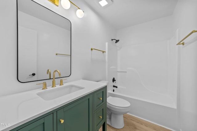 413 Top Greene Ln, Raleigh, NC 27601 - full bathroom featuring wood finished floors, toilet,  shower combination, and vanity