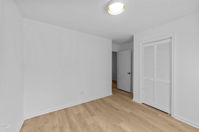 413 Top Greene Ln, Raleigh, NC 27601 - unfurnished bedroom with light wood-style floors, a closet, and baseboards