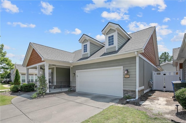 239 Nandina Ct Unit 21A, Fayetteville, NC 28311 - view of front of home with driveway, stone siding, an attached garage, and a porch
