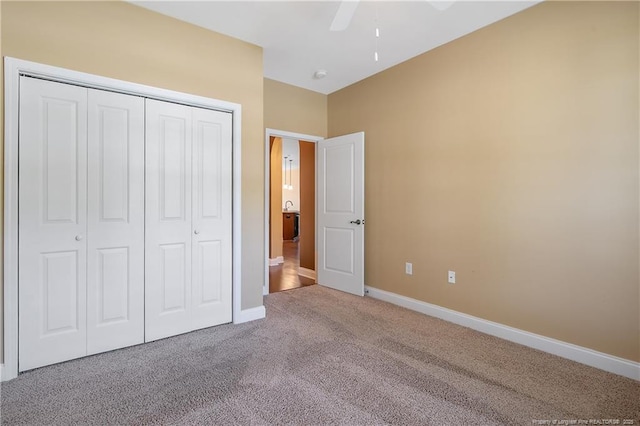 239 Nandina Ct Unit 21A, Fayetteville, NC 28311 - unfurnished bedroom featuring carpet flooring, a closet, baseboards, and a ceiling fan