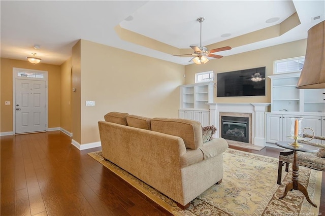 239 Nandina Ct Unit 21A, Fayetteville, NC 28311 - living area with a tray ceiling, baseboards, a ceiling fan, hardwood / wood-style floors, and plenty of natural light