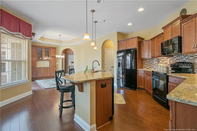 239 Nandina Ct Unit 21A, Fayetteville, NC 28311 - kitchen with black appliances, a sink, arched walkways, baseboards, and backsplash