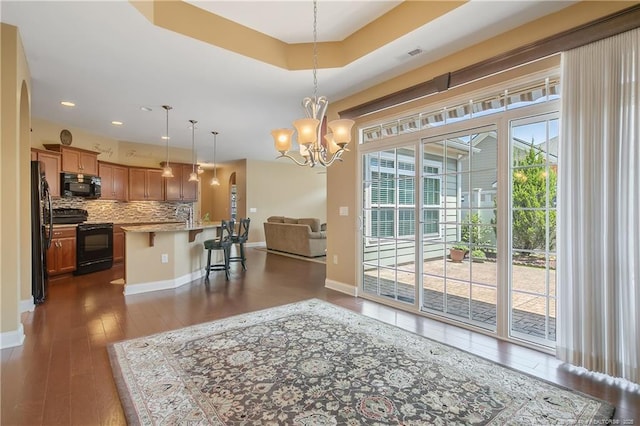 239 Nandina Ct Unit 21A, Fayetteville, NC 28311 - dining room with dark wood finished floors, a chandelier, recessed lighting, arched walkways, and baseboards