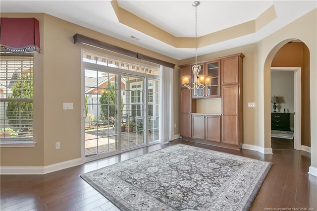 239 Nandina Ct Unit 21A, Fayetteville, NC 28311 - unfurnished dining area with a chandelier, baseboards, dark wood-style flooring, and plenty of natural light