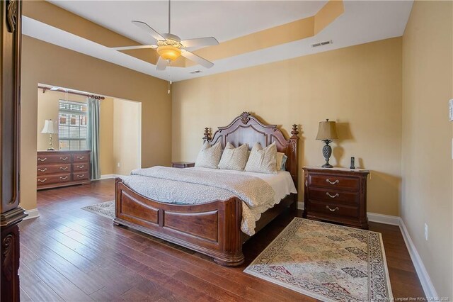 239 Nandina Ct Unit 21A, Fayetteville, NC 28311 - bedroom with a tray ceiling, hardwood / wood-style floors, baseboards, and a ceiling fan
