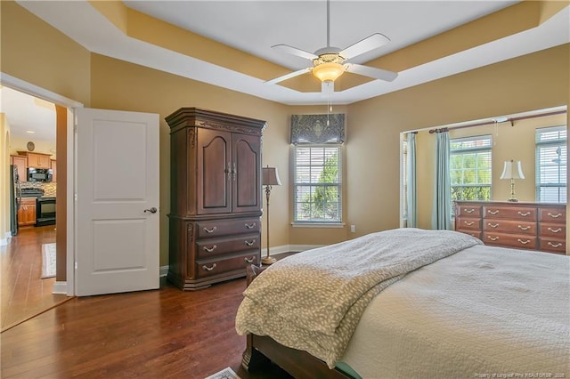 239 Nandina Ct Unit 21A, Fayetteville, NC 28311 - bedroom featuring dark wood finished floors, baseboards, ceiling fan, and a tray ceiling