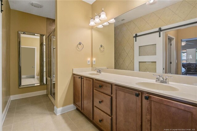 239 Nandina Ct Unit 21A, Fayetteville, NC 28311 - bathroom with double vanity, tile patterned flooring, baseboards, and a shower with shower door