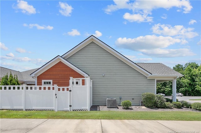 239 Nandina Ct Unit 21A, Fayetteville, NC 28311 - view of side of property with a gate, central AC unit, and a shingled roof