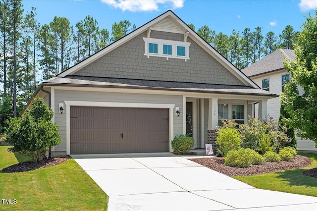 1724 Capstone Dr, Durham, NC 27713 - craftsman inspired home featuring concrete driveway, a garage, covered porch, and a front lawn