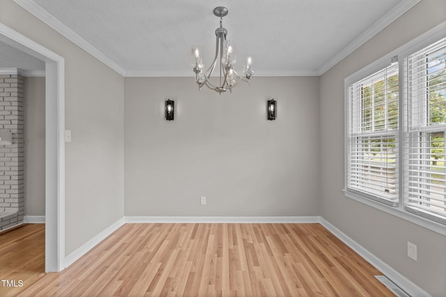 206 Bryant Cir, Goldsboro, NC 27534 - unfurnished dining area with a chandelier, light wood-style floors, baseboards, and ornamental molding