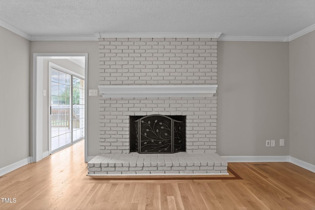 206 Bryant Cir, Goldsboro, NC 27534 - detailed view of wood finished floors, a textured ceiling, crown molding, baseboards, and a brick fireplace