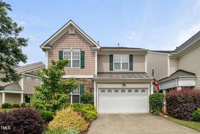 7873 Cape Charles Dr, Raleigh, NC 27617 - view of front of home with a garage, driveway, and a standing seam roof