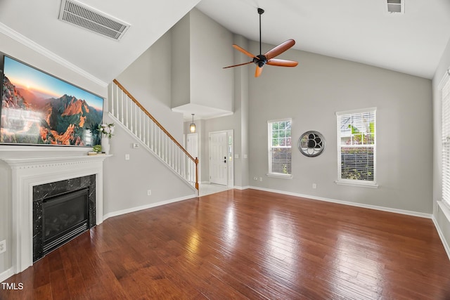 7873 Cape Charles Dr, Raleigh, NC 27617 - unfurnished living room featuring stairway, a ceiling fan, wood-type flooring, a fireplace, and high vaulted ceiling