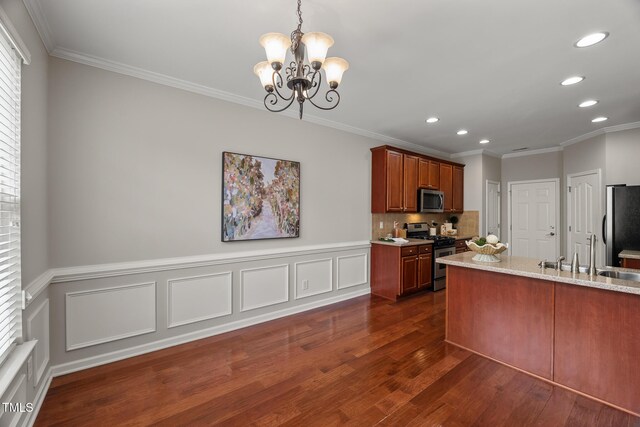 7873 Cape Charles Dr, Raleigh, NC 27617 - kitchen with stainless steel appliances, recessed lighting, a chandelier, dark wood finished floors, and crown molding